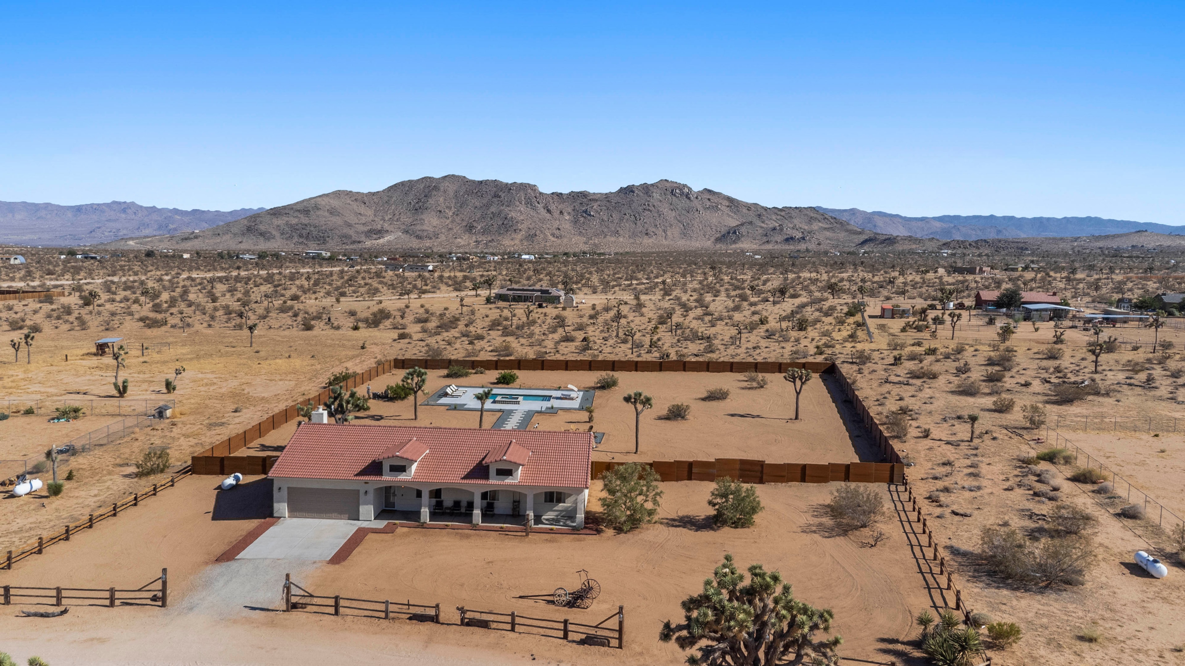 Aerial view of Waning Moon Ranch showing the property, pool, and Joshua Tree desert landscape