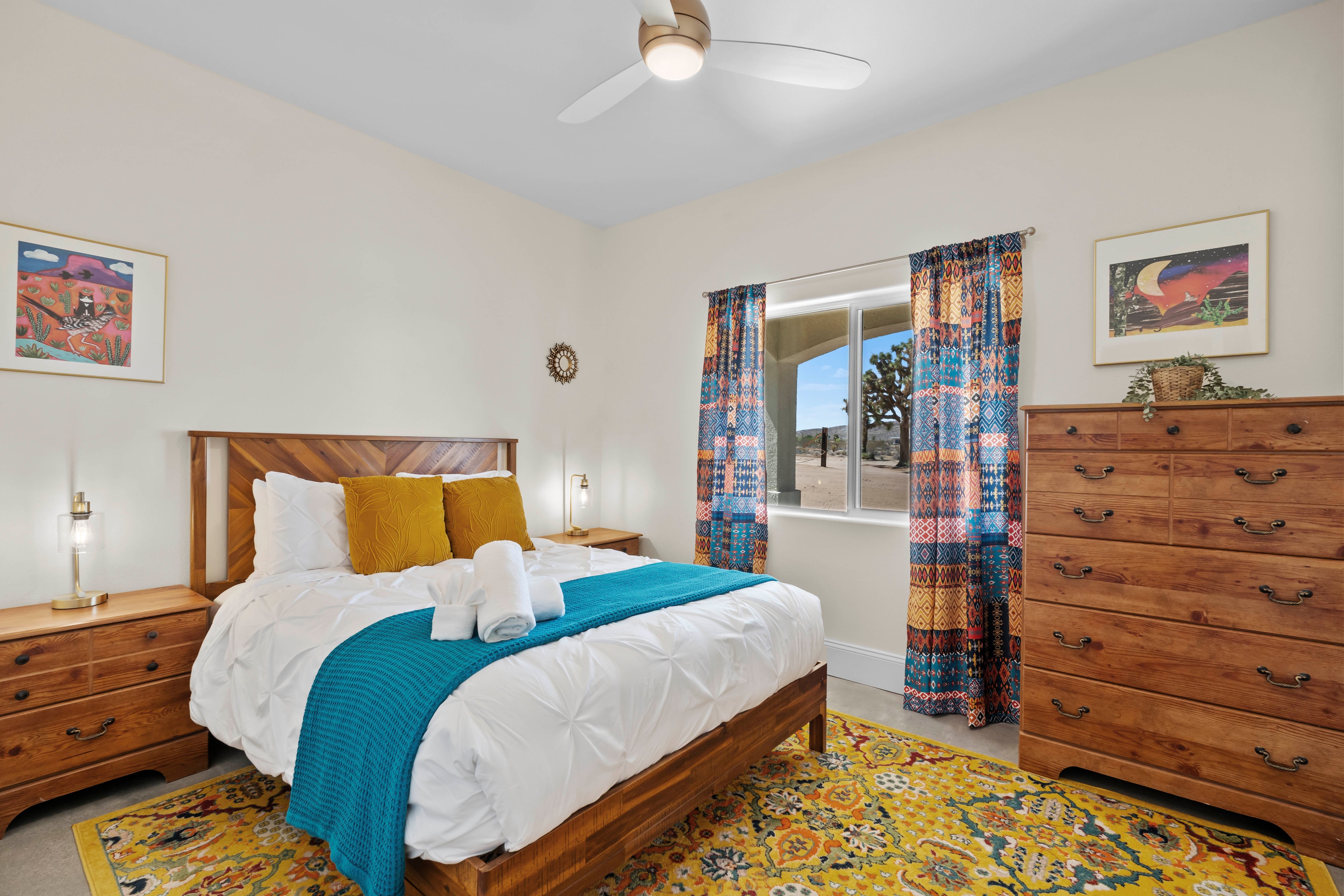 Guest Room One with queen bed and colorful desert decor at Waning Moon Ranch